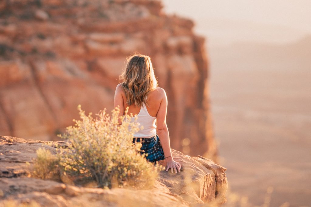 woman sitting on rock in southern utah for mental health